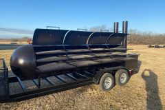 racks inside of large bbq pit on trailer