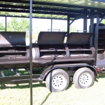 large smoker/grill on trailer with roof and awning