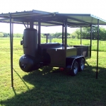 large smoker/grill on trailer with roof and awning