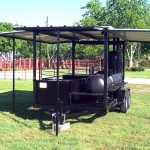 large smoker/grill on trailer with roof and awning