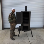 person next to vertical smoker