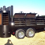 racks inside of large double bbq pit on trailer