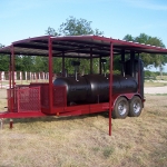 large bbq pit on trailer with roof and awning