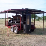 large bbq pit on trailer with roof and awning