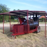 large bbq pit on trailer with roof and awning