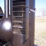 racks inside of large dual grill on trailer