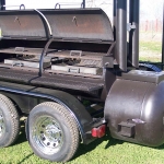 racks inside of medium smoker on trailer with roof